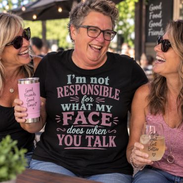 Three women laughing together at a café.