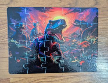 A dinosaur-themed jigsaw puzzle with a T-Rex and cowboys on horses.