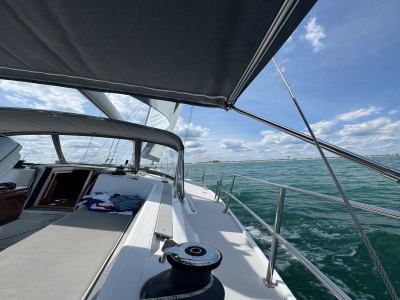 View from a yacht deck under a canopy overlooking the sea.