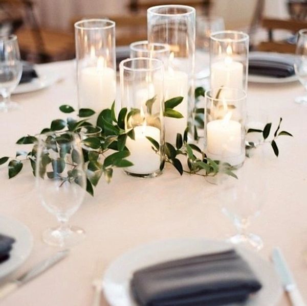 Cylinder candles as a centerpiece on wedding table