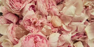 Close-up of delicate pink rose petals and crystals.