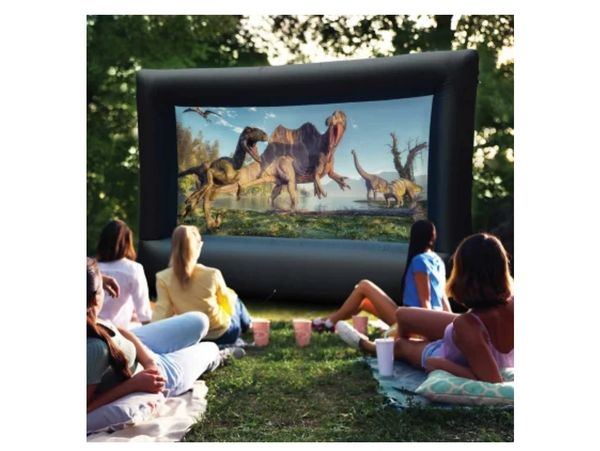 The backyard movie setup features a large outdoor screen, projector, and the best sound!