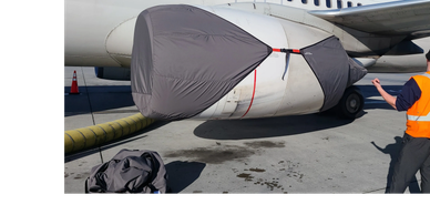 Protective covers on airplane engine and intake.