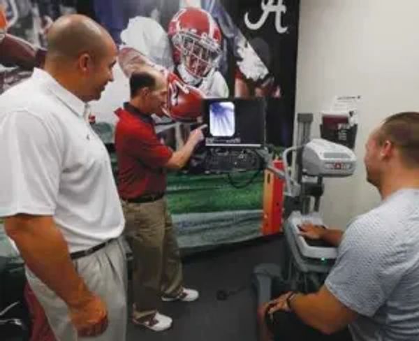 Dr. Martin Schwartz (center), with Alabama football trainer, Jeff Allen (left)