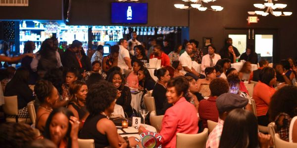 Crowded restaurant with lively social gathering.