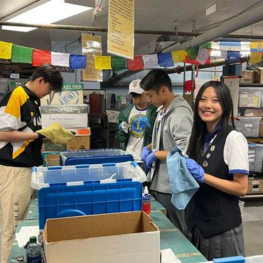 Group preparing and handling items in a storage area.
