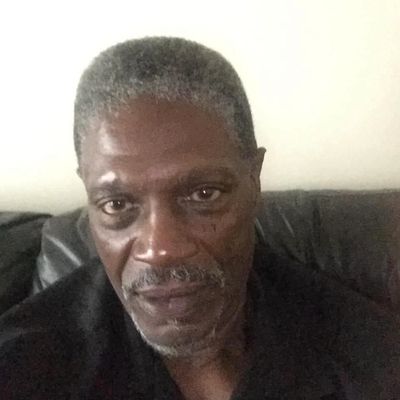 Portrait of an older man with gray hair and a mustache.