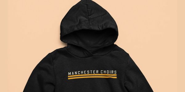 Black hoodie with 'Manchester Choirs' text and yellow lines.
