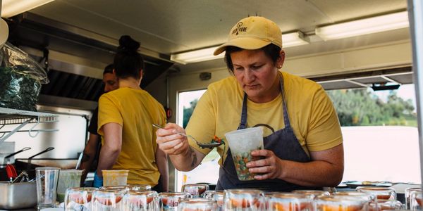 Candidate Amy Huo as a small business owner preparing meals in her food truck. 