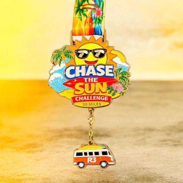 Smiling sun medal with sunglasses, an ocean and beach scene, and a colorful surf van charm.