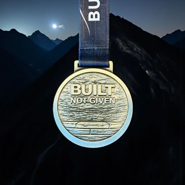 Built Not Given medal with a brick foundation.