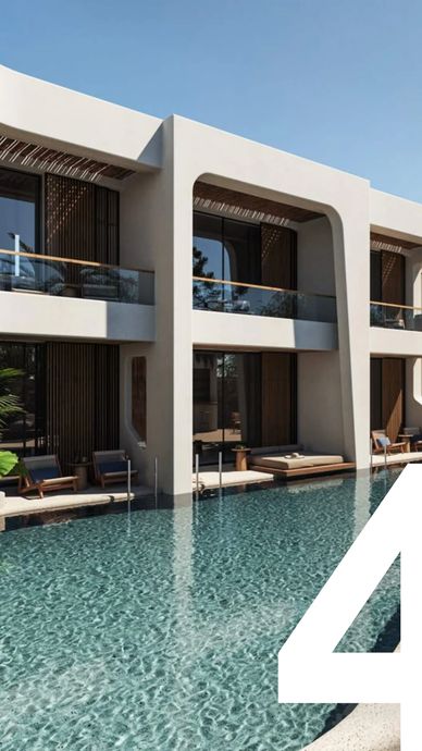 Modern villa with a pool and outdoor lounge area under clear skies.