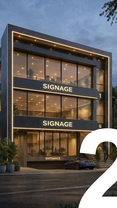 Modern commercial building with illuminated signage and glass facade at dusk.