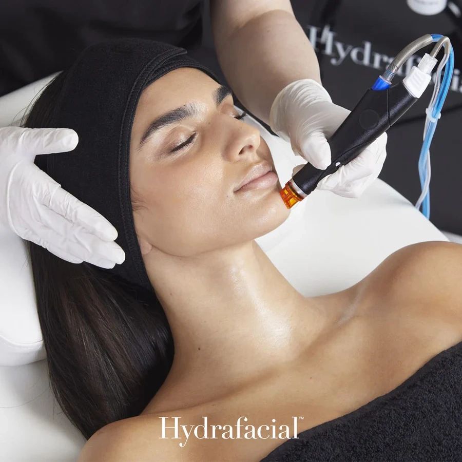 Woman receiving a Hydrafacial treatment on her face.