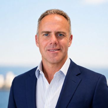 Professional man in a suit with ocean background.