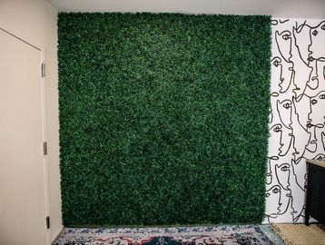 The faux-grass wall at The Film Garage 208 studio for photographers in Idaho Falls, Idaho.