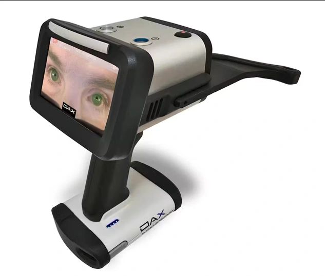 A DAX electronic magnifier with a screen displaying a close-up of eyes.