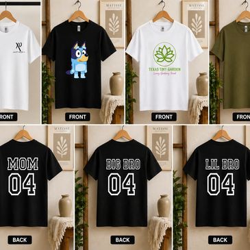 Set of multi themed graphic t-shirts hanging indoors.