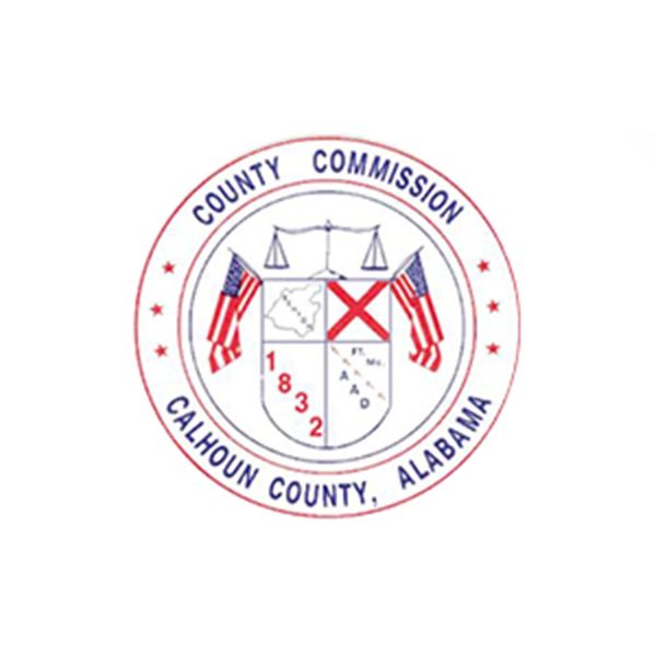Seal of Calhoun County Commission, Alabama, featuring flags and scales of justice.