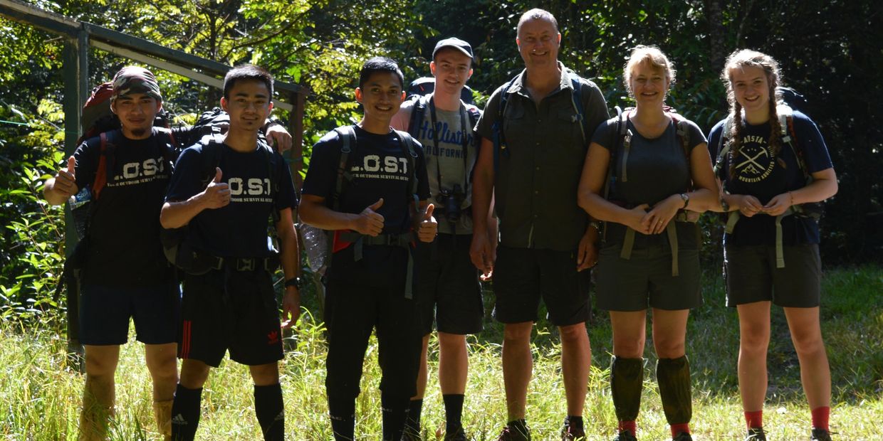 Photo of a family at the starting point of the trail at Maliau Basin