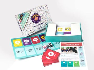 Educational game kit laid out with cards, dice, and instructions.