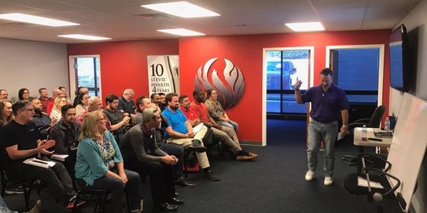 A speaker presenting to an engaged audience in a conference room.