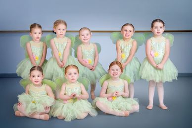 Young girls dressed as fairies in a dance studio.