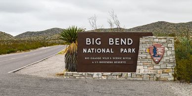 Entrance sign for Big Bend National Park in a desert landscape.