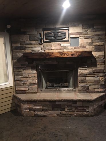 Rustic fireplace mantel on a stone fireplace