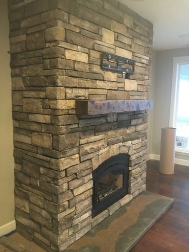 Rustic fireplace mantel on a stone fireplace