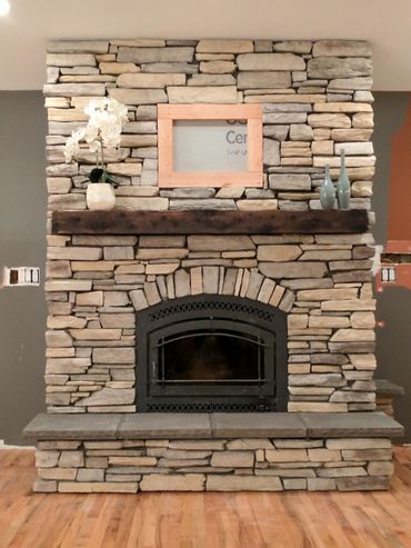 Rustic fireplace mantel on a stone fireplace