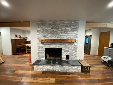 Rustic fireplace mantel on a stone fireplace