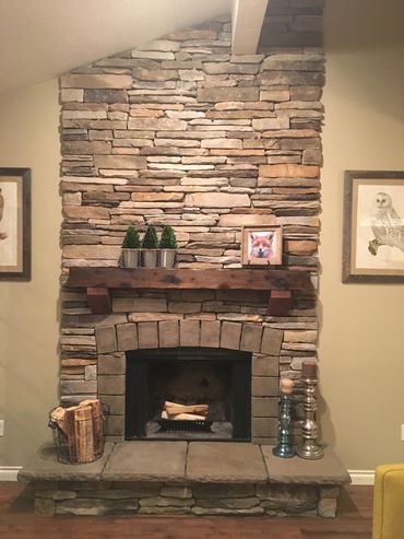 Rustic fireplace mantel on a stone fireplace