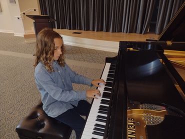 Musician playing piano in concert hall