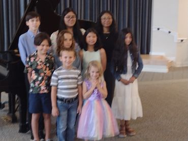 Child pressing piano keys with focus