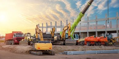 Construction site with heavy machinery representing pumping and maintenance services for industrial projects.