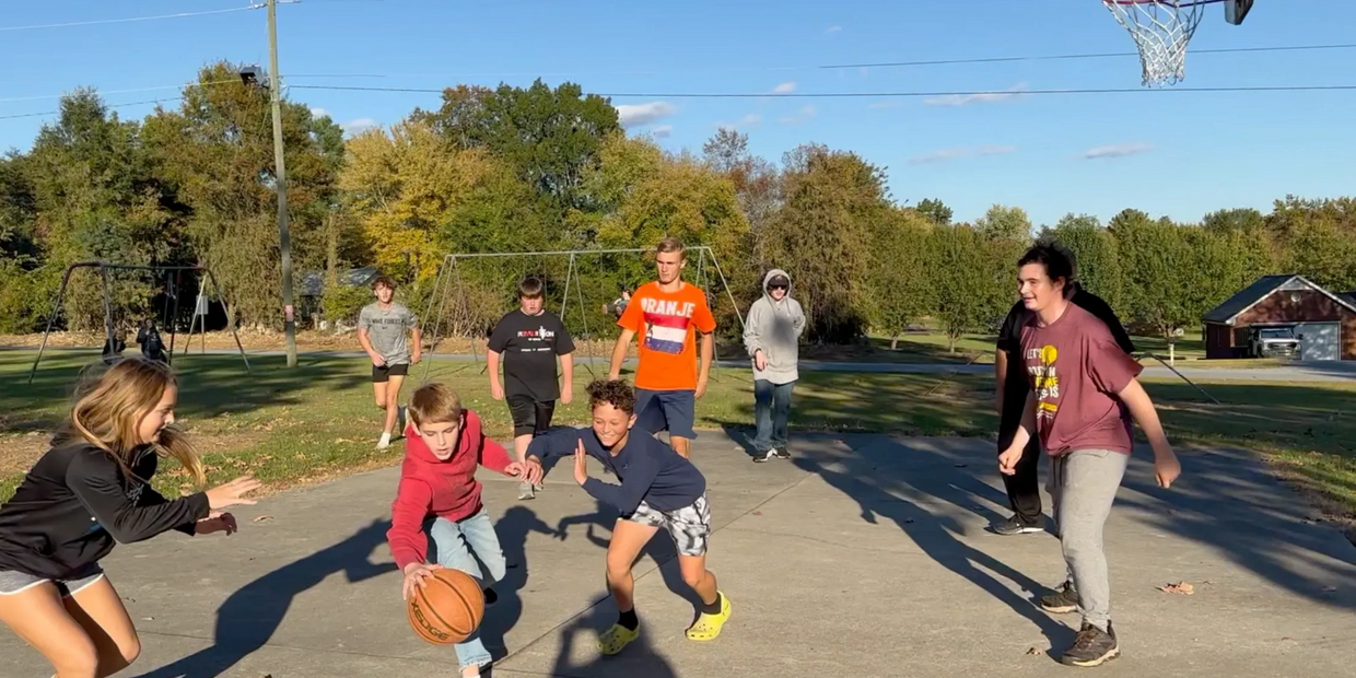 Group of youth playing basketball outside