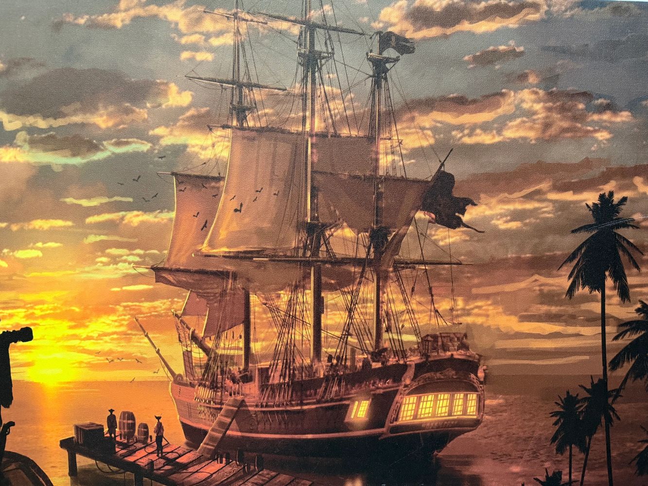 Stack of books next to pencils in a holder and a camera.