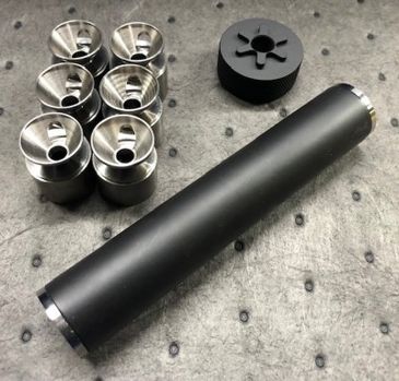 A black cylindrical object with metallic components on a textured surface.