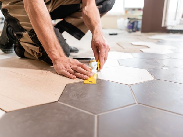 A professional installing floor tiles