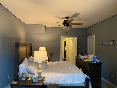 Cozy bedroom with a large bed, wooden furniture, and soft lighting.