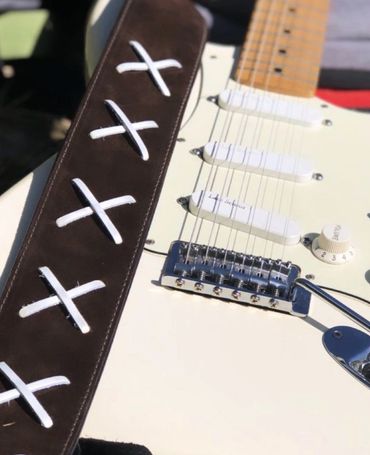 Gilmour guitar strap attached to a white fender Stratocaster 