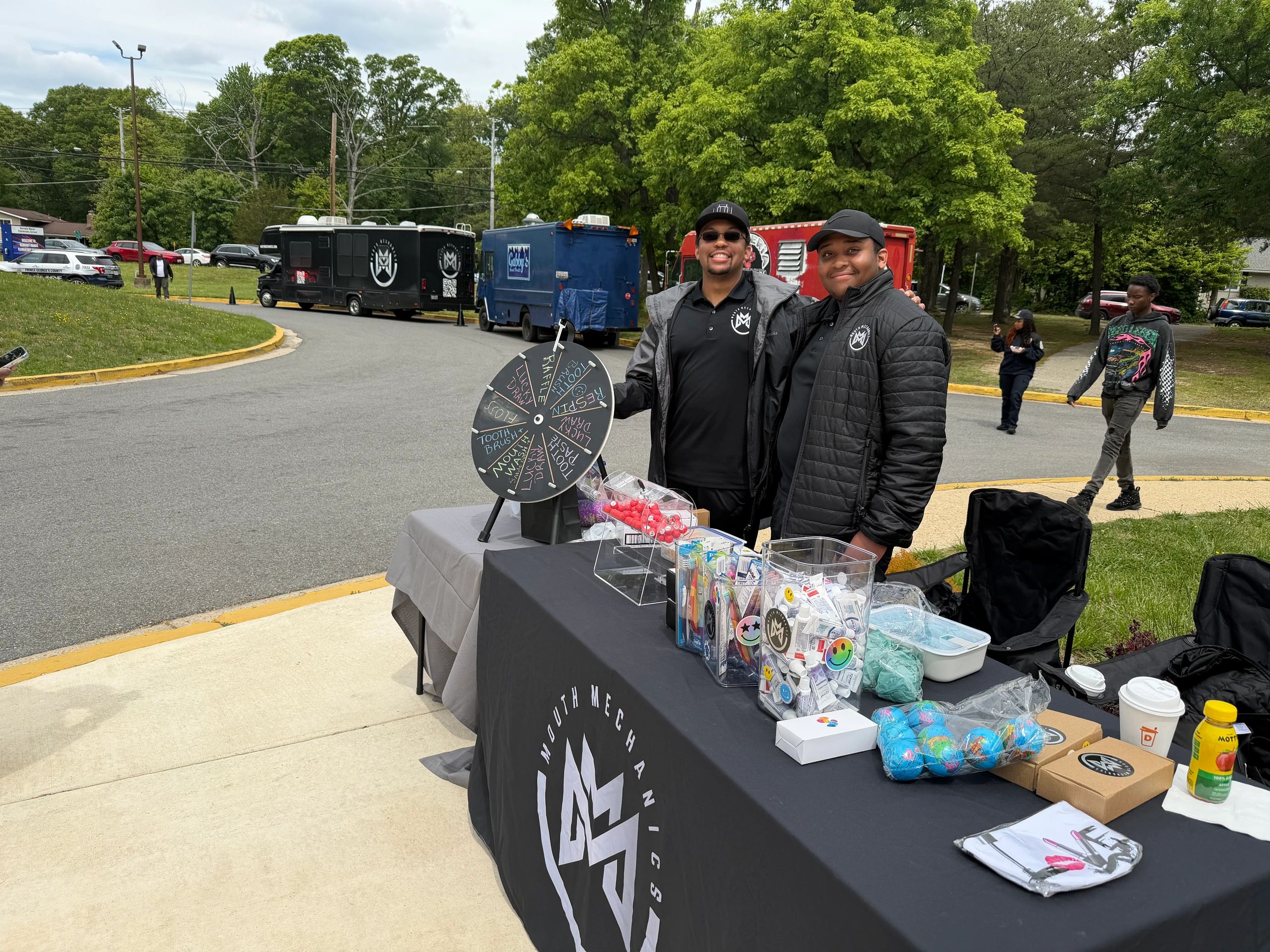 Joshua and Jaylen Black representing Mouth Mechanics Charities Inc. at a community outreach event.