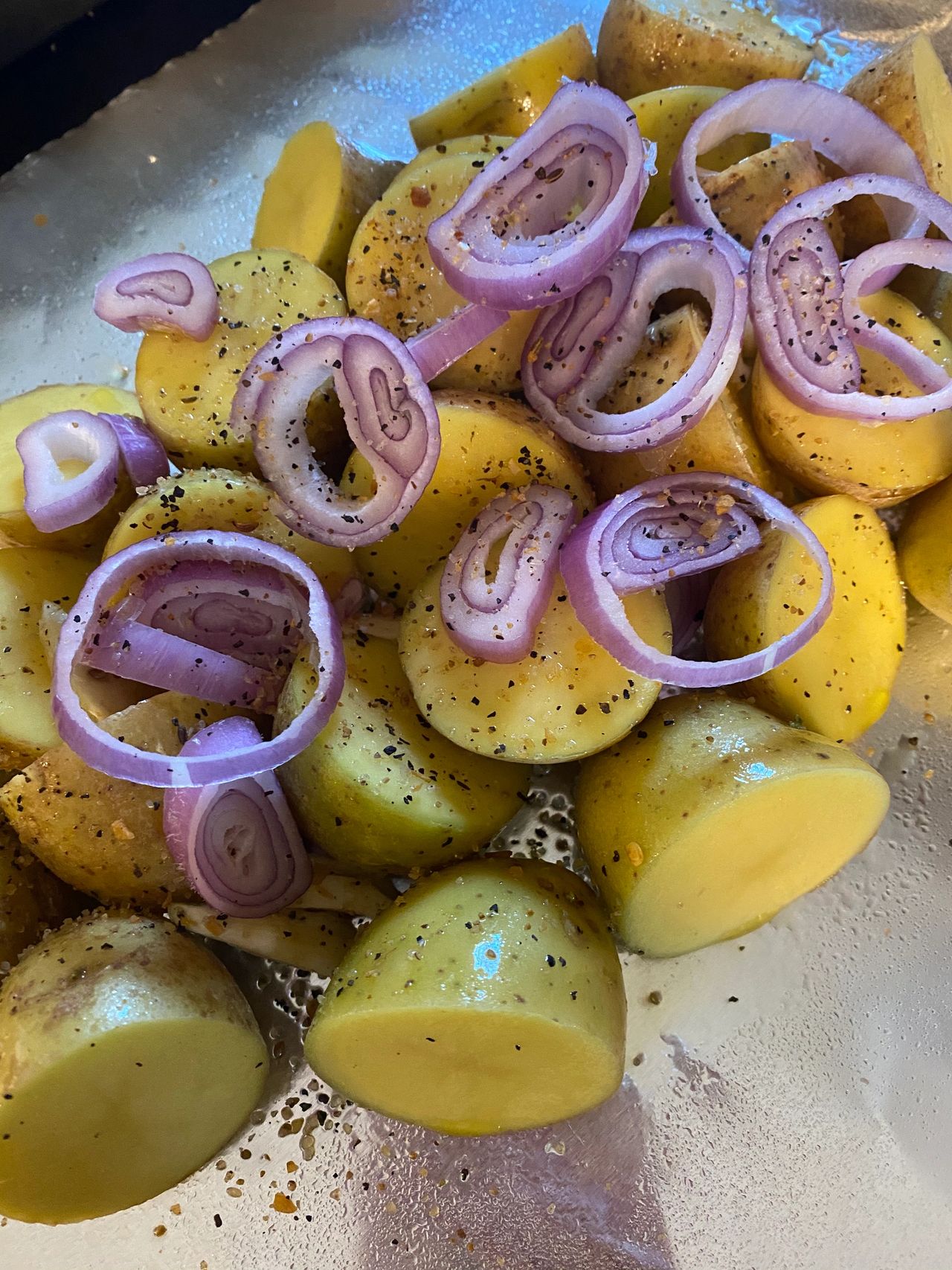Preparing foil-wrapped baby potatoes for the campfire