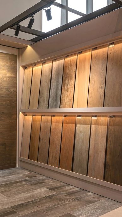Wood flooring samples displayed on a wall.