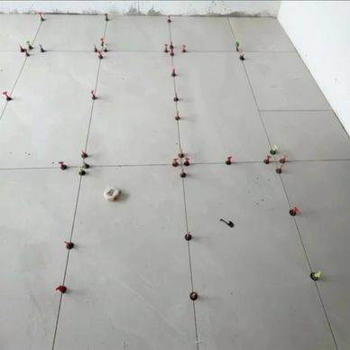 Floor tiles being installed with spacers