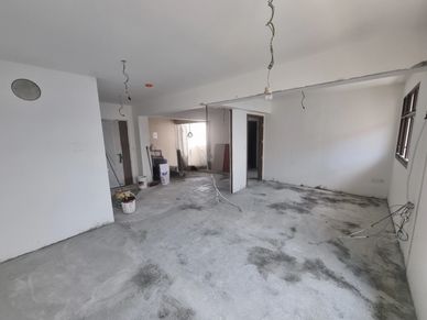 Empty room under construction with unfinished floor.