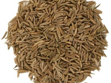 Close-up of a pile of brown cumin seeds on a white background.