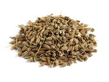 Pile of dried celery seeds on a white background.