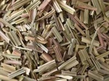 Close-up of dried lemongrass pieces in a bowl.